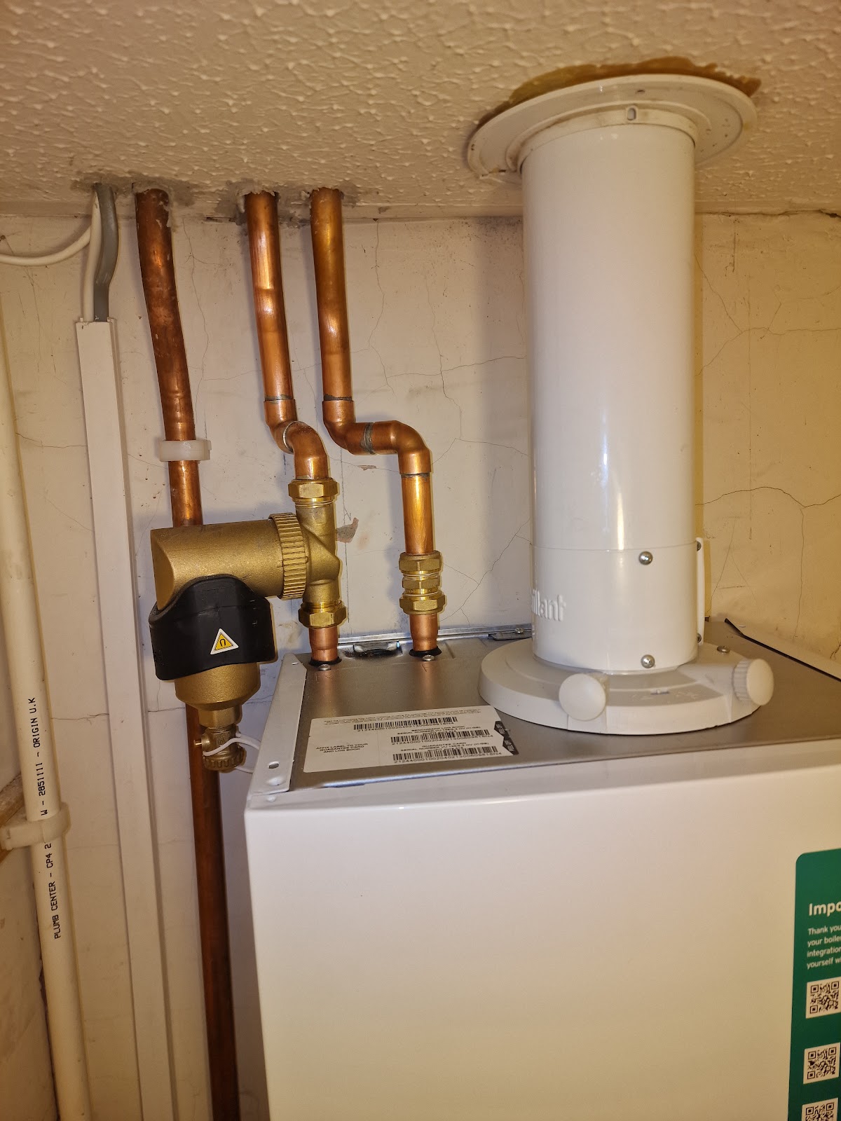 Copper pipework and brass valve above a newly fitted boiler