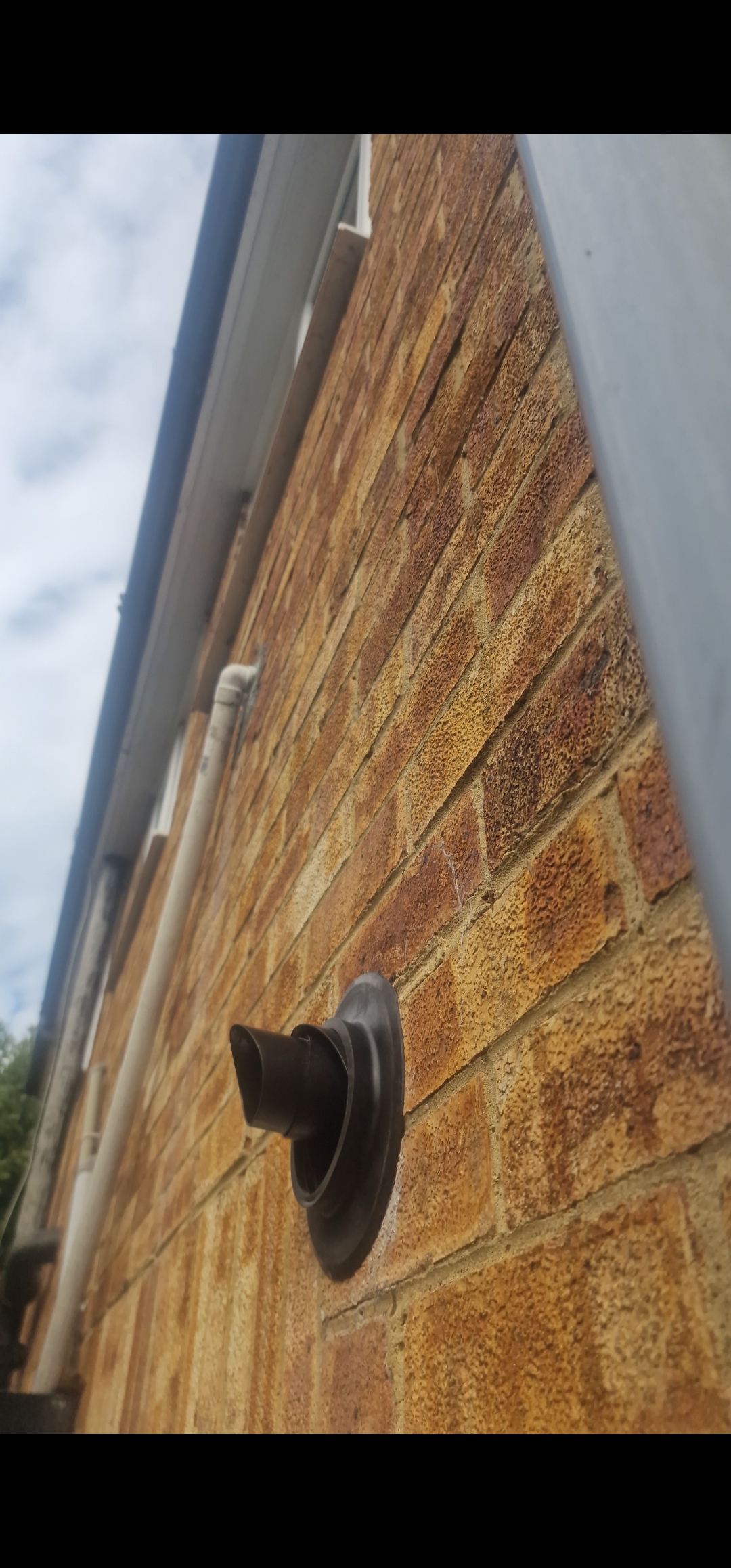 External boiler flue terminal fitted through a brick wall